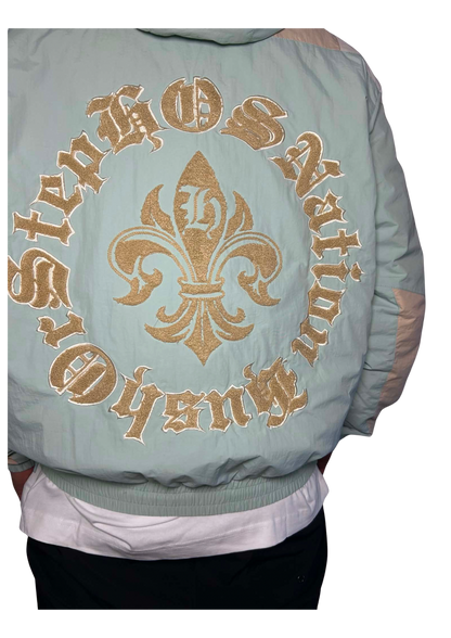 Light blue bomber jacket with gold embroidery on a white background